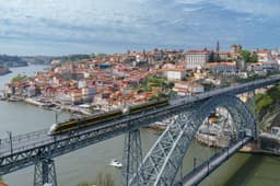 Porto cityscape with Dom Luis I Bridge over the Douro River at golden hour