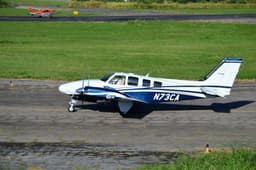 A budget carrier aircraft taxiing on the runway at a busy airport