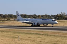 Breeze Airways aircraft with blue livery parked at terminal