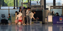 Airport security checkpoint with TSA PreCheck lane and standard screening line