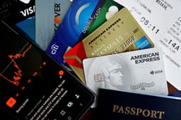 American Express Platinum card with travel documents and booking materials