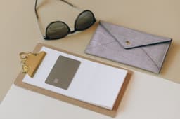 Amex Gold and Platinum credit cards with travel booking in background