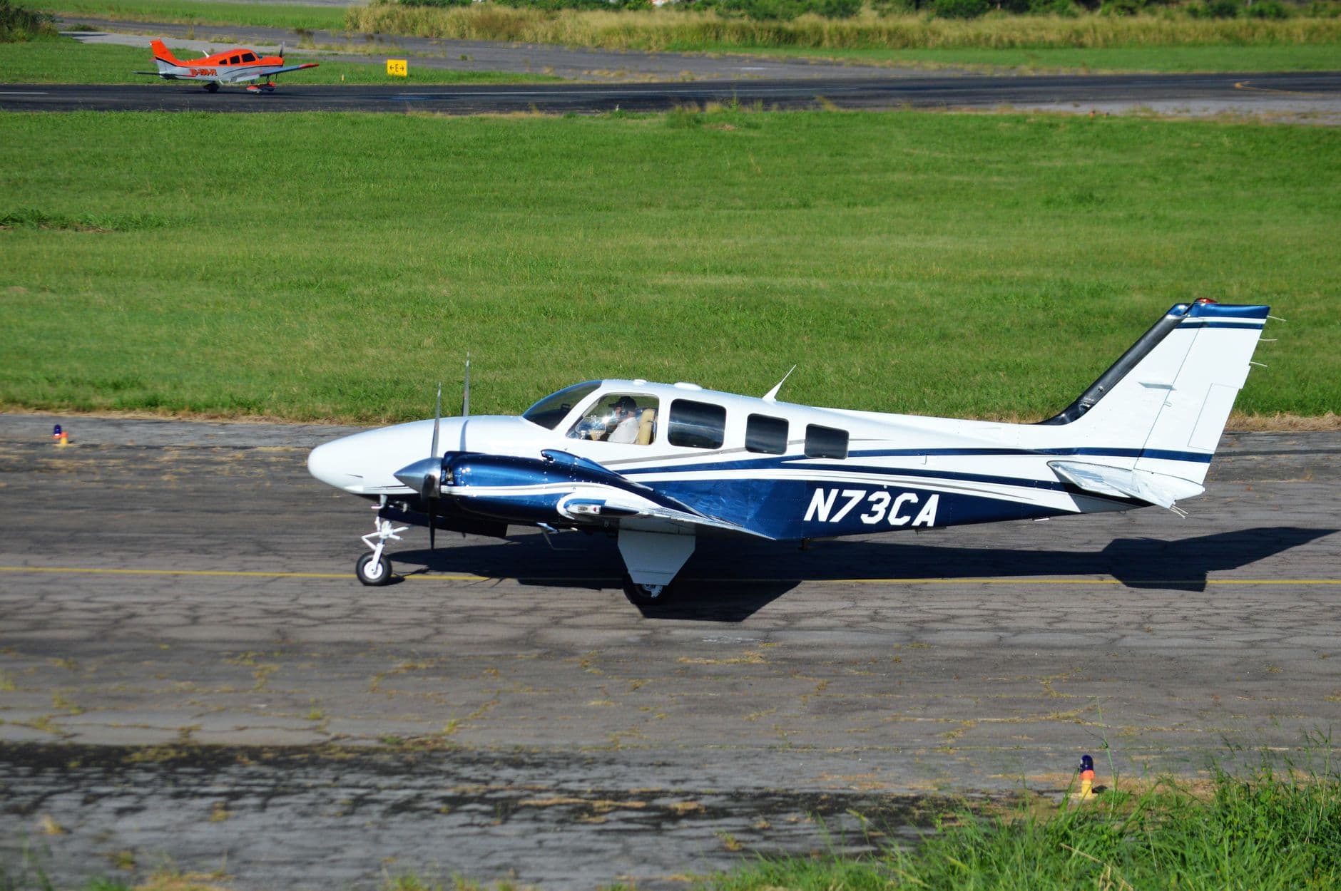 A budget carrier aircraft taxiing on the runway at a busy airport
