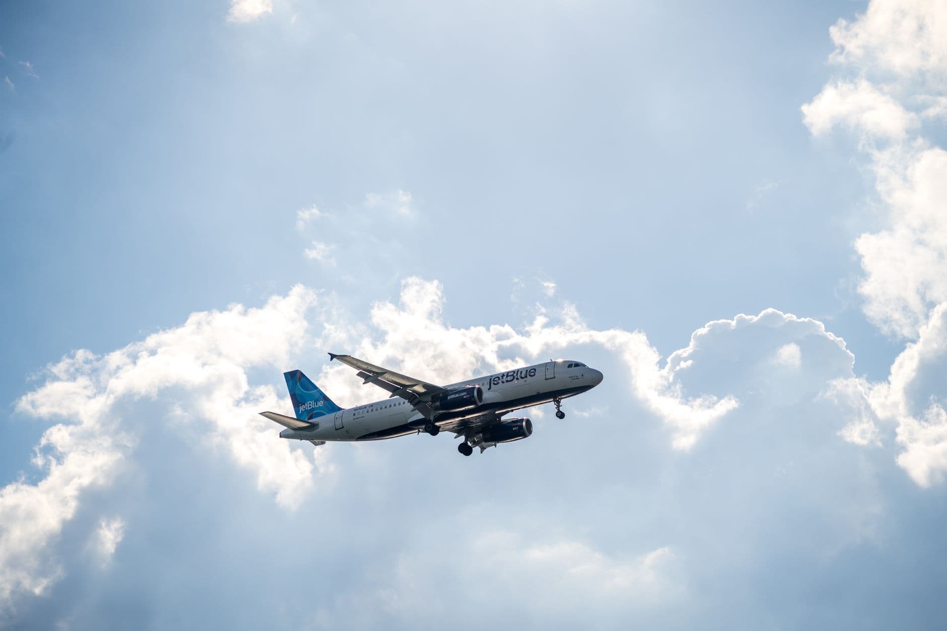 JetBlue Airways aircraft with blue mosaic tailfin at airport gate