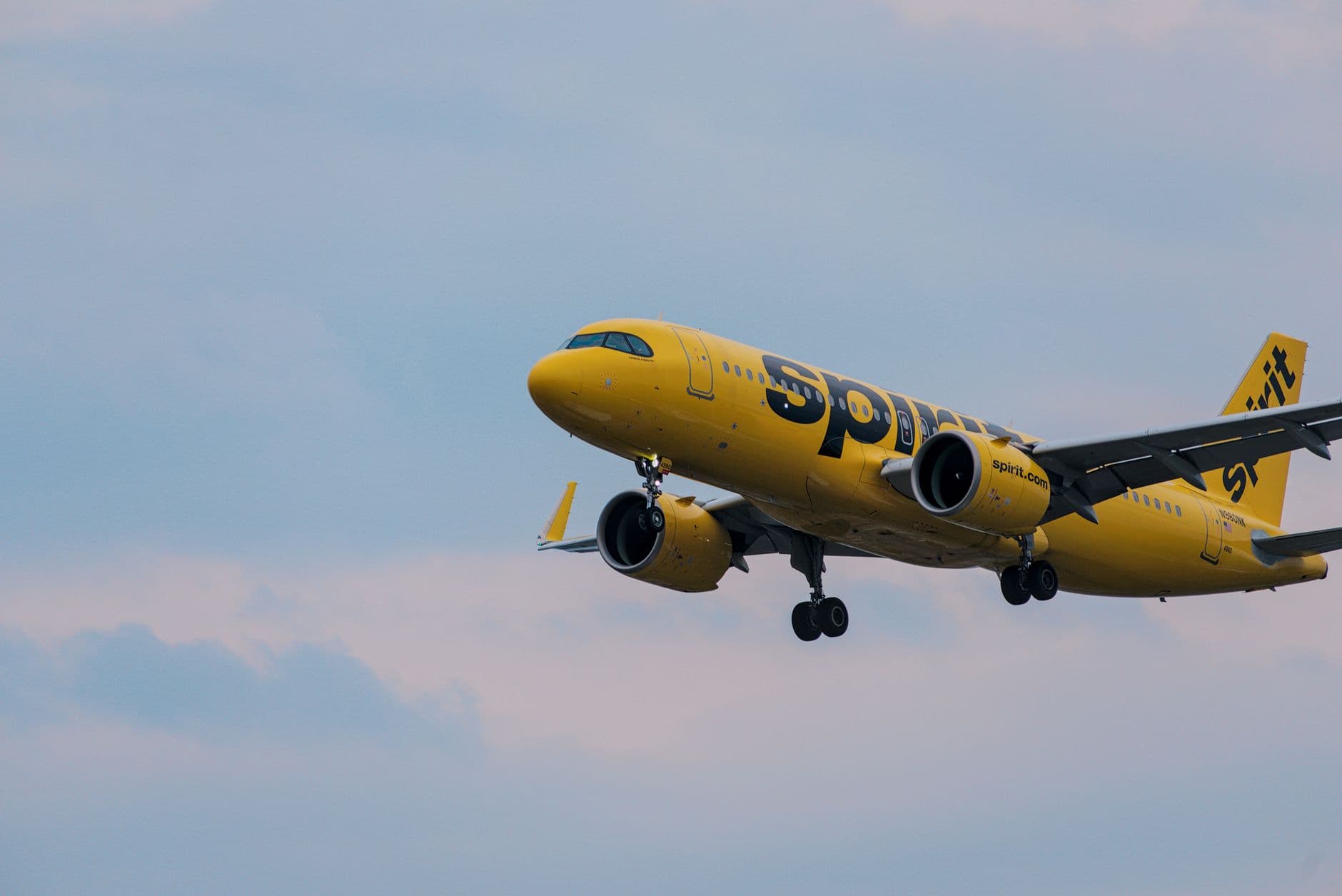Spirit Airlines yellow aircraft on runway preparing for departure