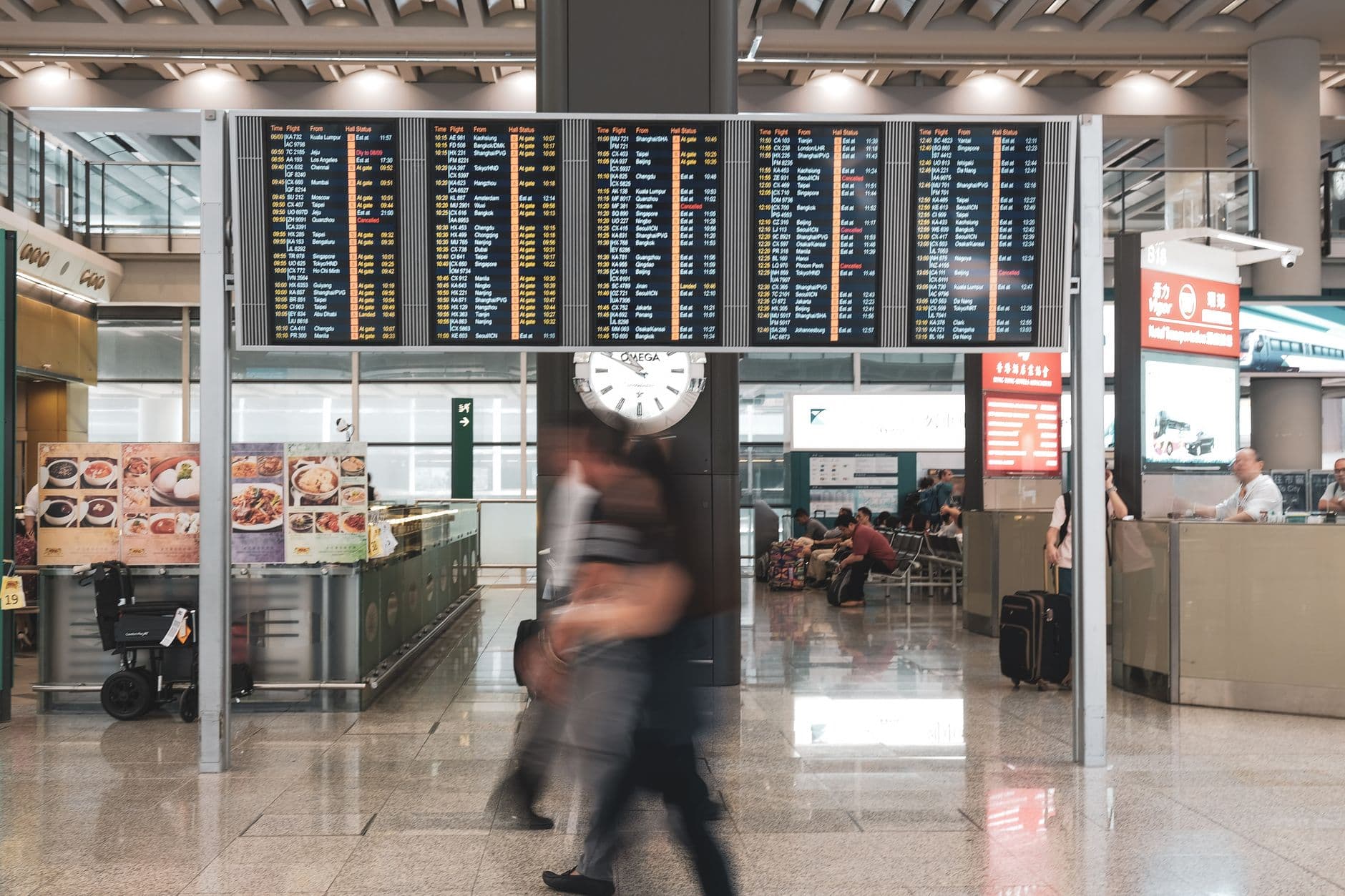 Airport departure board showing flight status and gate information
