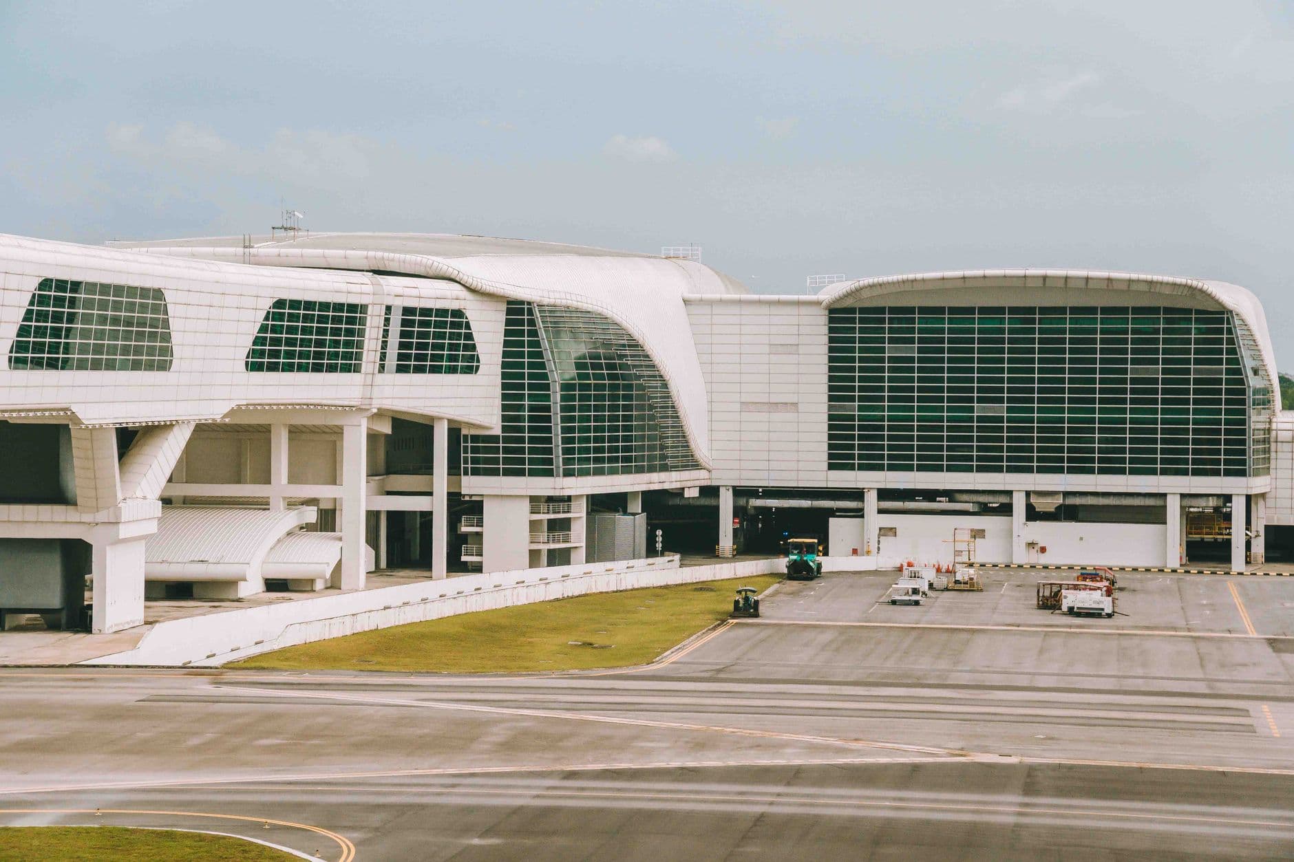 Modern airport exterior building with glass facade and clear sky
