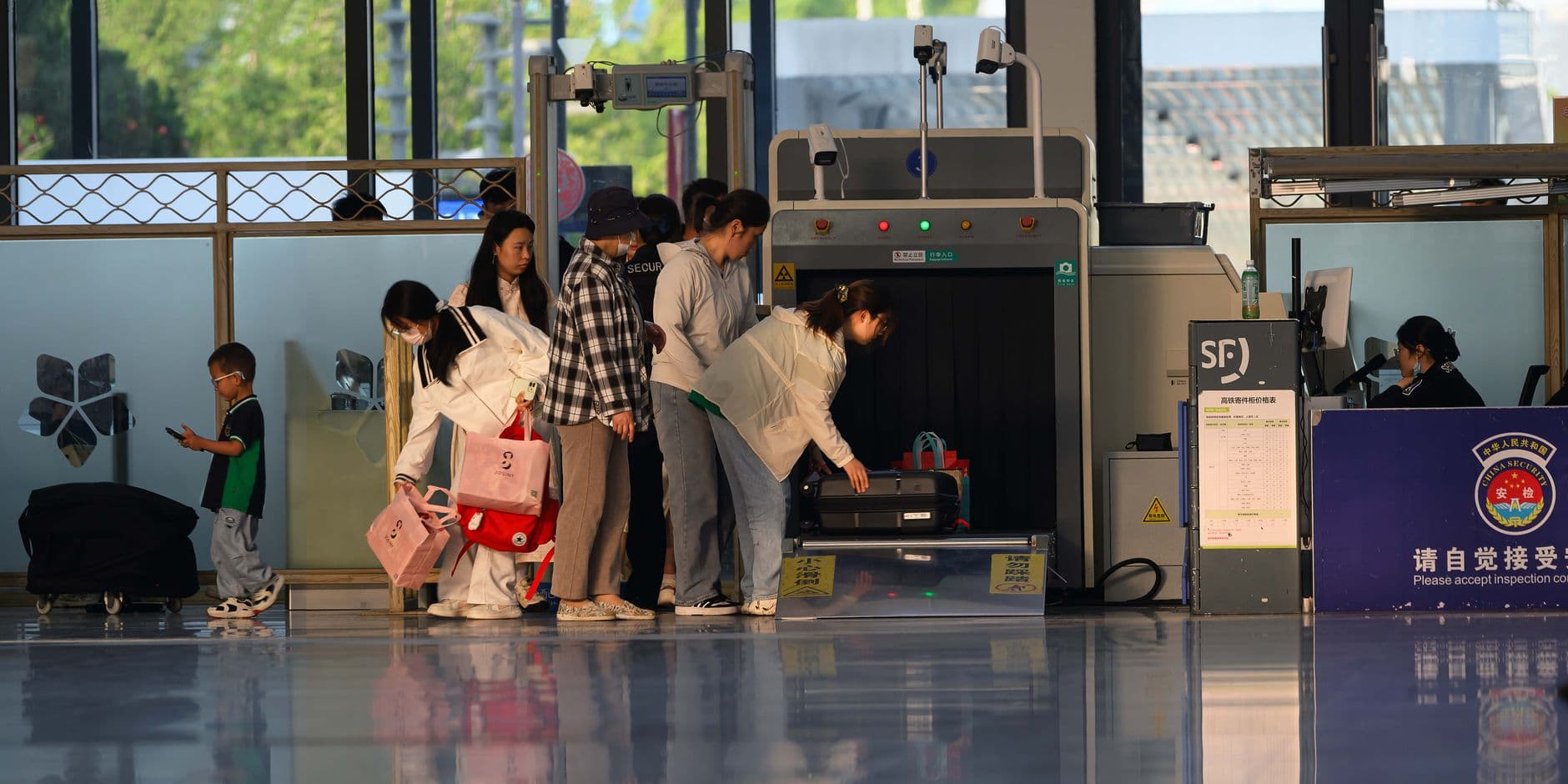 Airport security checkpoint with TSA PreCheck lane and standard screening line