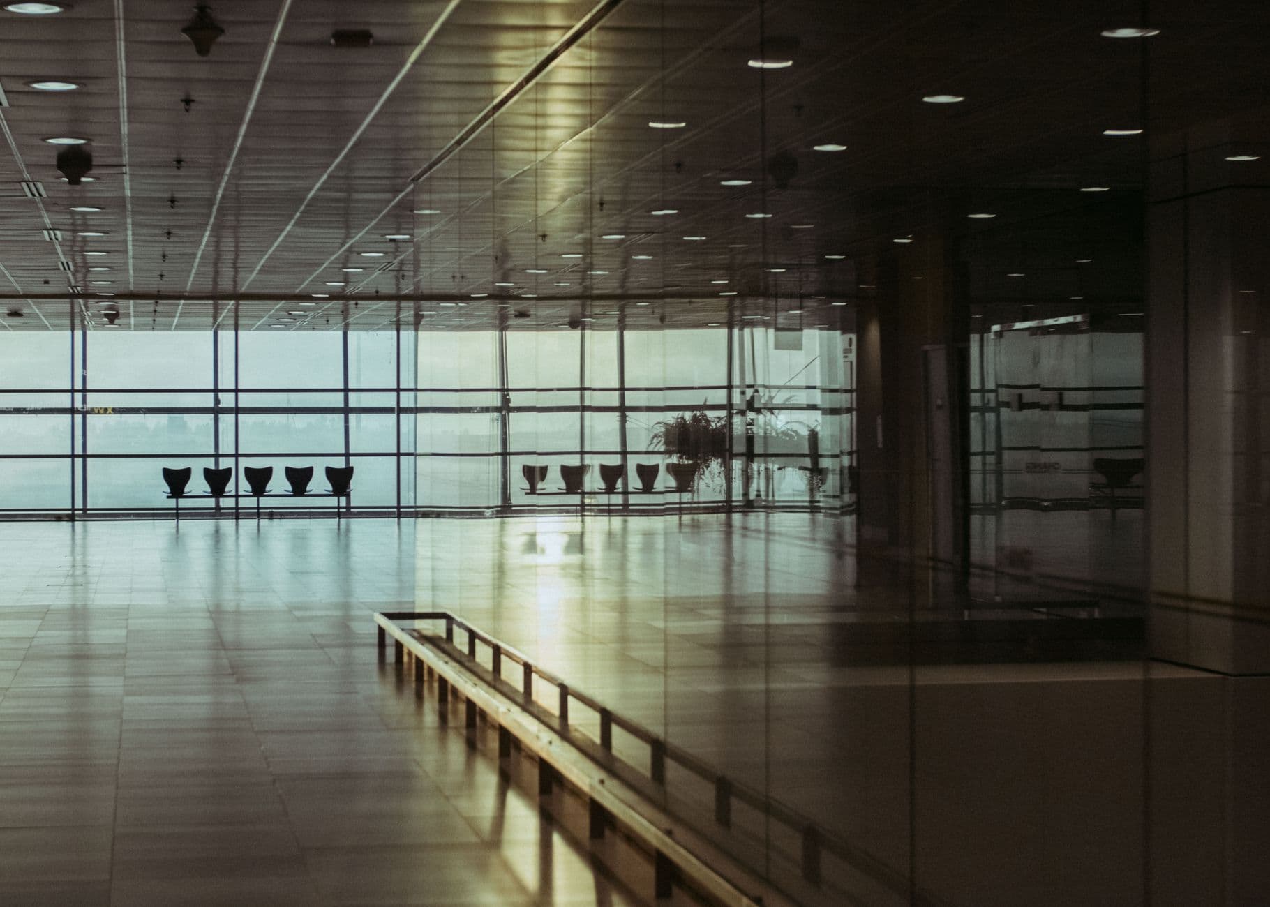 Spacious airport terminal with modern architecture and passengers walking