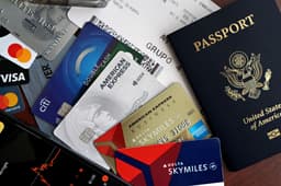 A traveler checking a loyalty points balance, representing miles saved for someday