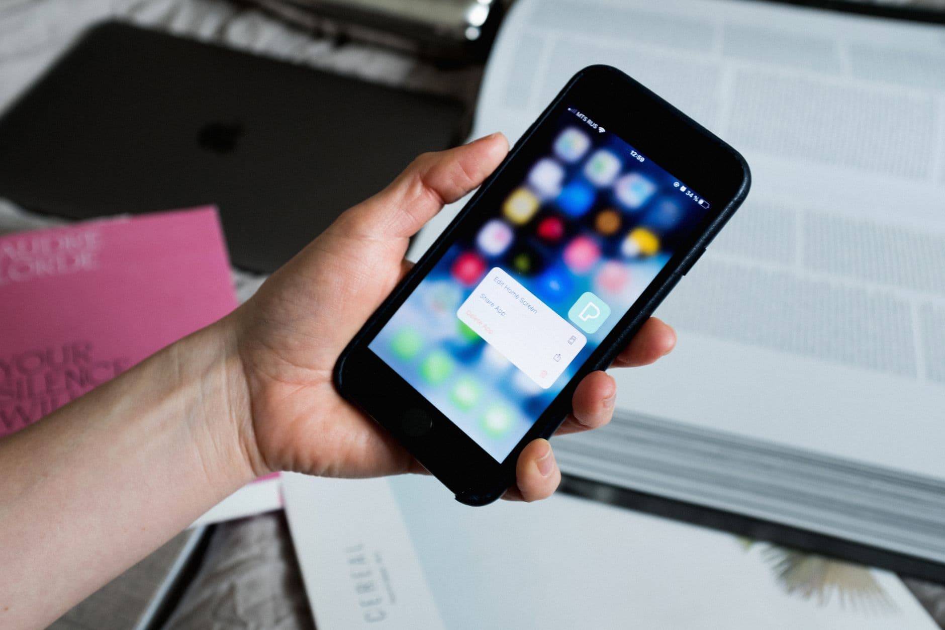 Person booking a flight on smartphone app with boarding pass visible