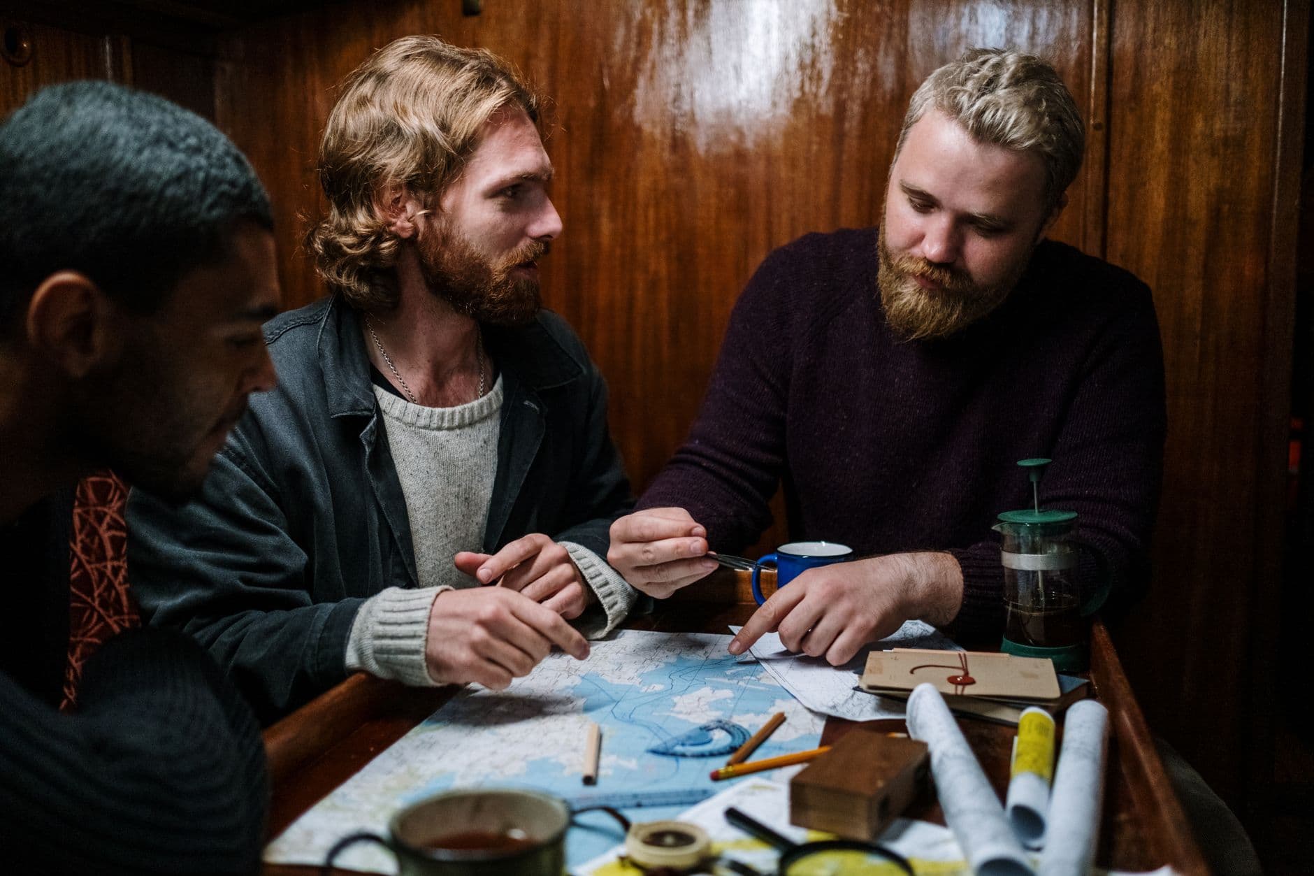 Travel planning with map, coffee, and notebook on desk