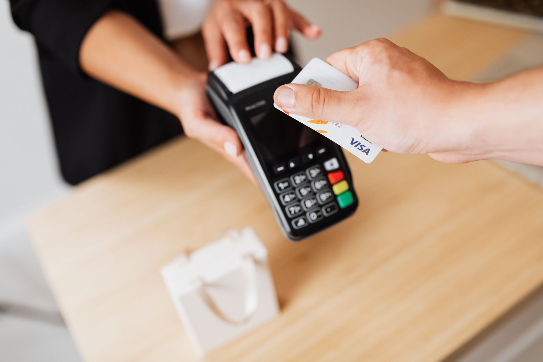 Person tapping credit card at payment terminal